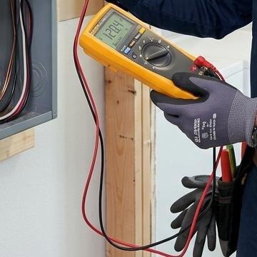Electrician testing circuit voltage with a multimeter in Winter Haven